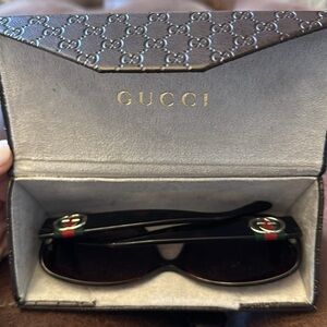 Gucci sunglasses with foldable case.